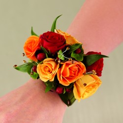 The FTD Sweet Sunshine Wristlet from Lloyd's Florist, local florist in Louisville,KY