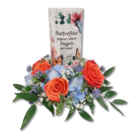 Glass candle in the middle of fresh flowers